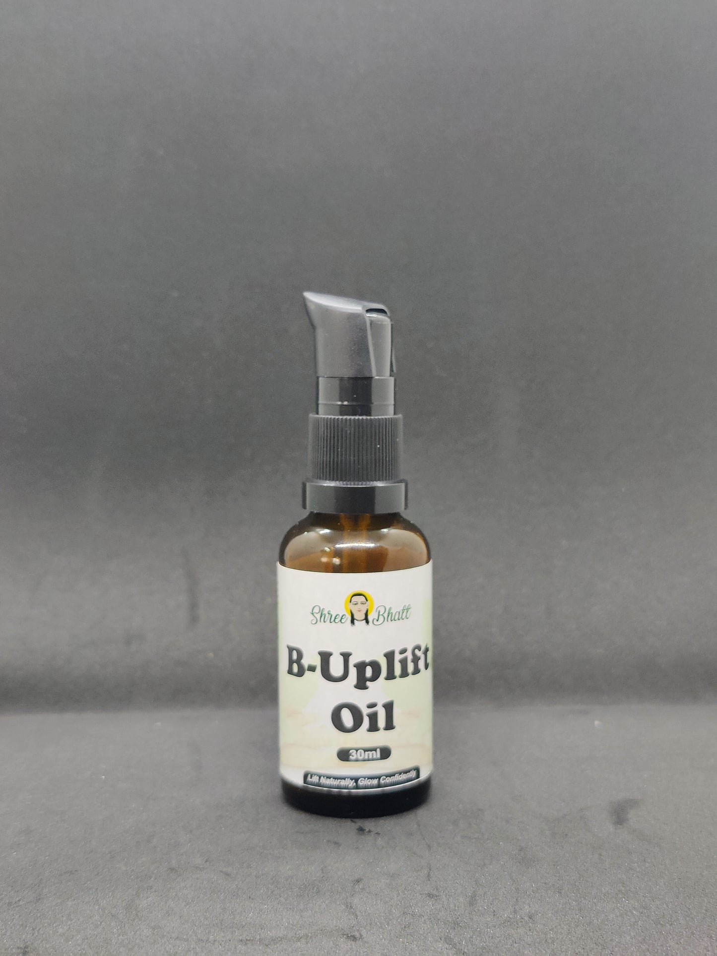 A bottle of B-Uplift Oil with a dropper, on a dark background.